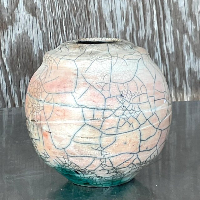 A fantastic vintage Boho vase. A chic Raku crackle finish in the most beautiful pale pink. Flashes of green peeking thru....