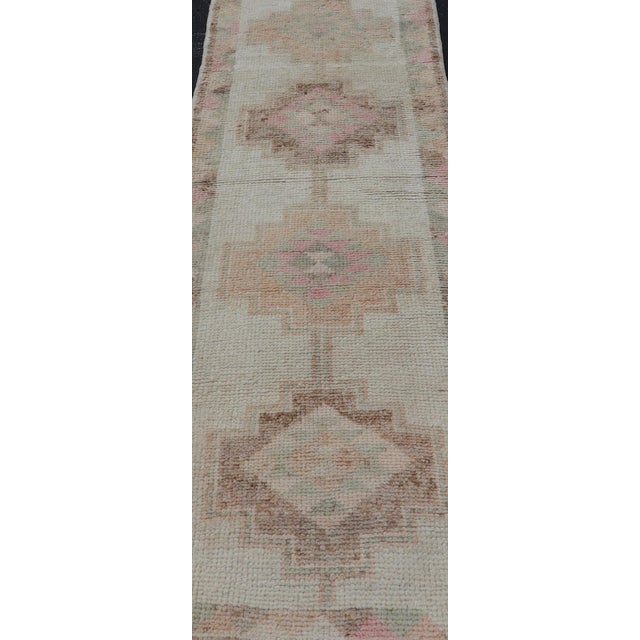 Measures: 2'10 x 9'6 This charming Vintage Turkish Tulu runner features a delicate blend of soft pastel and beige tones,...