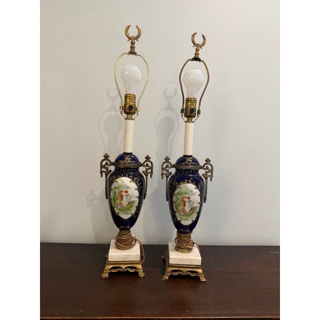 Add timeless elegance to your home with this stunning pair of Sevres-style blue porcelain table lamps. Featuring a rich...