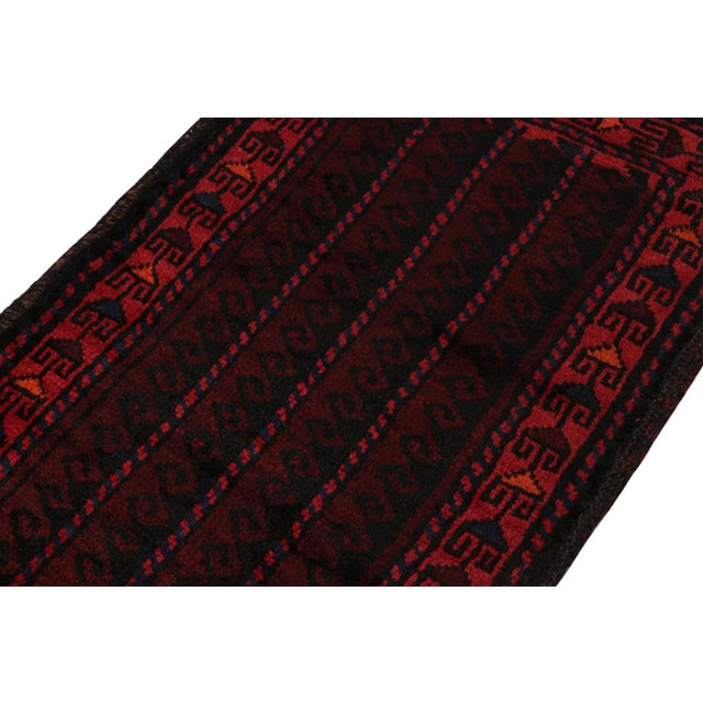 Hand knotted in wool, this 2x4 Baluch scatter rug represents a new line of tribal carpets in the Modern Classics...