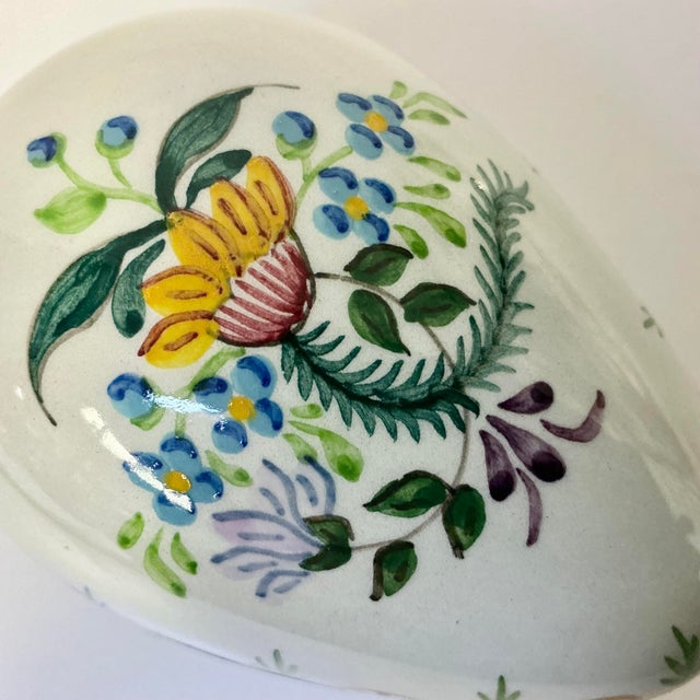 This porcelain Egg Trinket Box is from Portugal and beautifully hand painted. The ground is a very pale blue and the top...