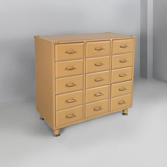 Italian post modern chest of drawers in beige leather, 2000s Rectangular chest of drawers with fifteen drawers divided...