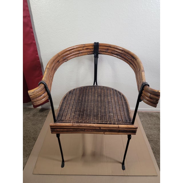 These vintage rattan and wrought iron chairs showcase a unique blend of organic materials and industrial design. The...