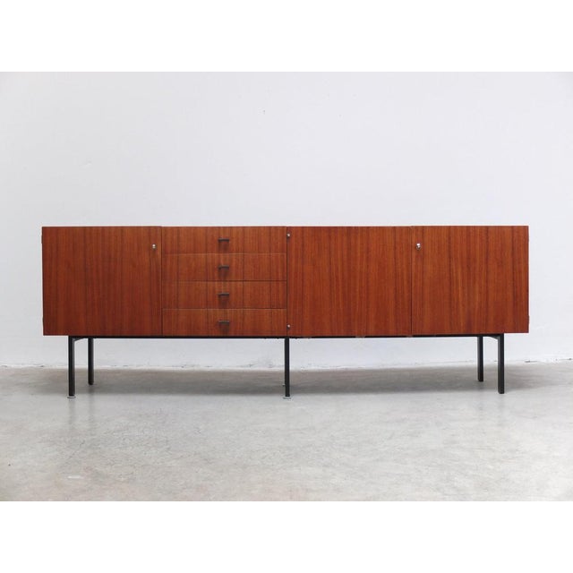 Large sideboard designed by Belgian modernist architect Roger De Winter for E.M.Y. around 1960. Made of teak wood combined...