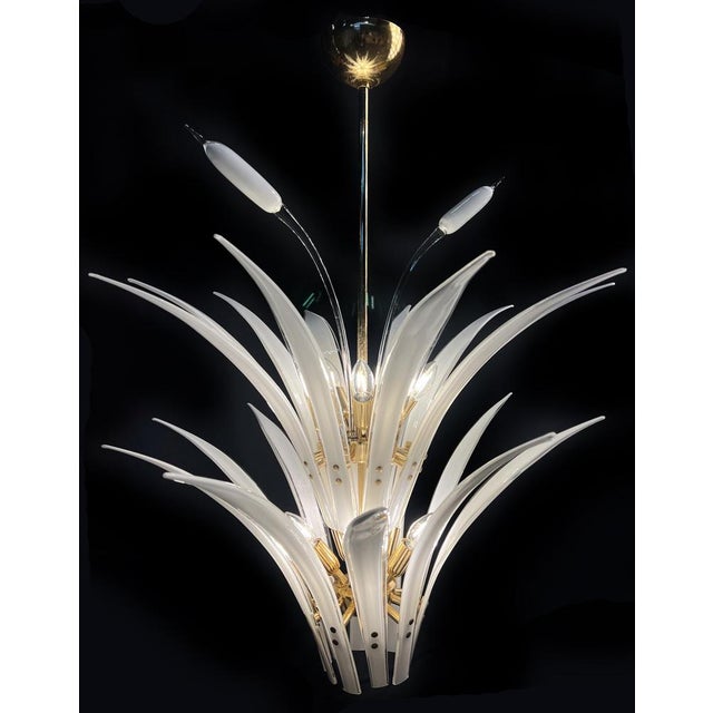 The chandelier consist of 20 palm leaves, 10 lights e14 3 flowers 20 leaves 46 cm. This piece is attributed to the...