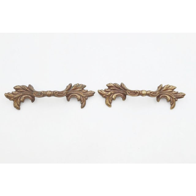 Vintage French Provincial style drawer pulls made of brass with a patina finish. The original mounting screws are not...