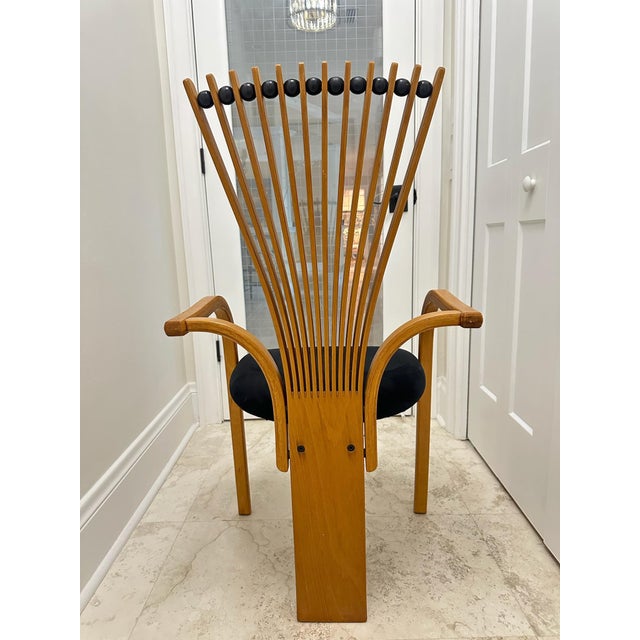 A wonderfully distinctive 1990s Postmodern armchair featuring an architectural fan-shaped back formed by slender radiating...