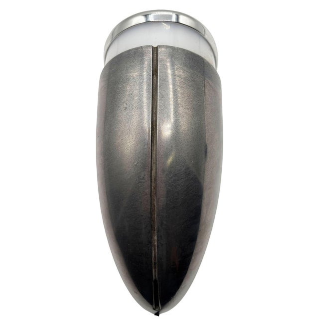 One brushed aluminum Streamline Art Deco wall sconce featuring a round body with a lucite cutout for accent lighting along...