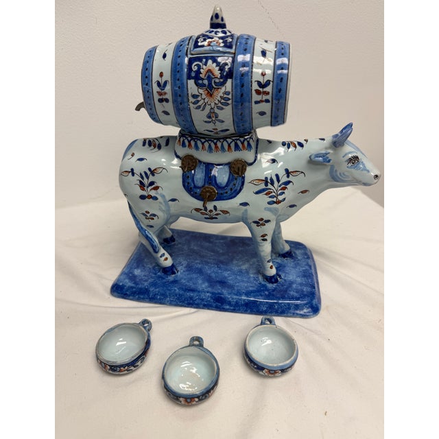 Extraordinary polychrome faience cow liquor dispenser attributed to Georges Martel of Desvres, France. Three hanging...