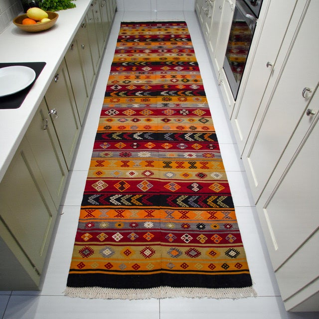 A warm, heritage-rich Anatolian kilim runner handwoven with dense cicim embroidery that brings depth, culture, and...
