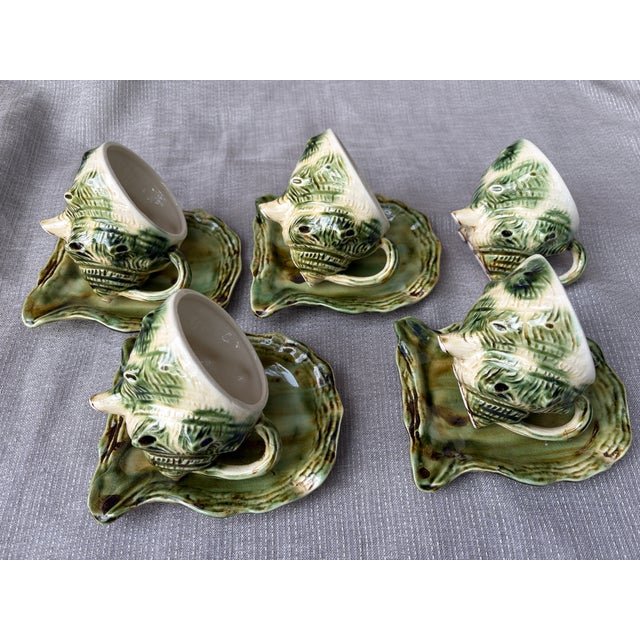 Vintage whimsical coastal set of Majolica style ceramic shell cup and saucer sets, 5 cups and 4 saucers. Crafted in the...
