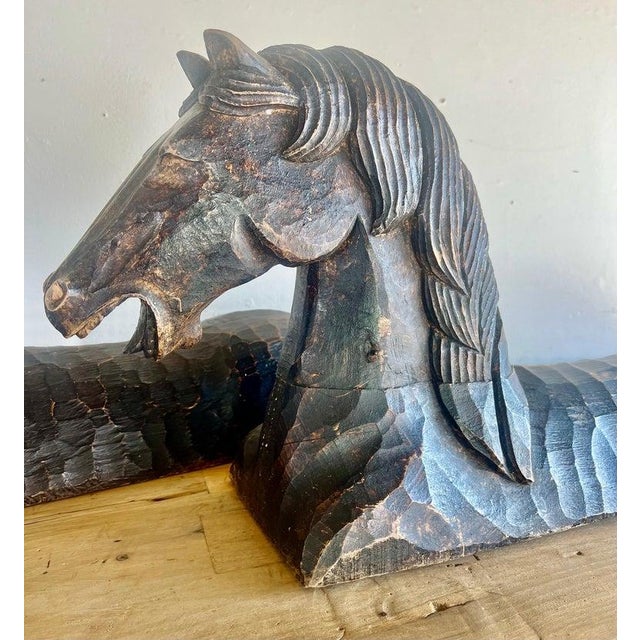 Two hand-chiseled horse sculptures with a primitive aesthetic. Their weathered finish adds character and suggests a sense...