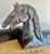 Two hand-chiseled horse sculptures with a primitive aesthetic. Their weathered finish adds character and suggests a sense...