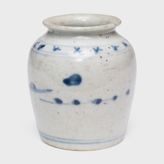 Sweeping blue brushstrokes bring this petite, early 20th-century apothecary jar to life, marking its speckled glaze with a...