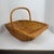 Purchased at Fortnum & Mason, London in 1980, a lovely woven wicker flared shape gathering basket . 21 1/2" Long X 12" w X...