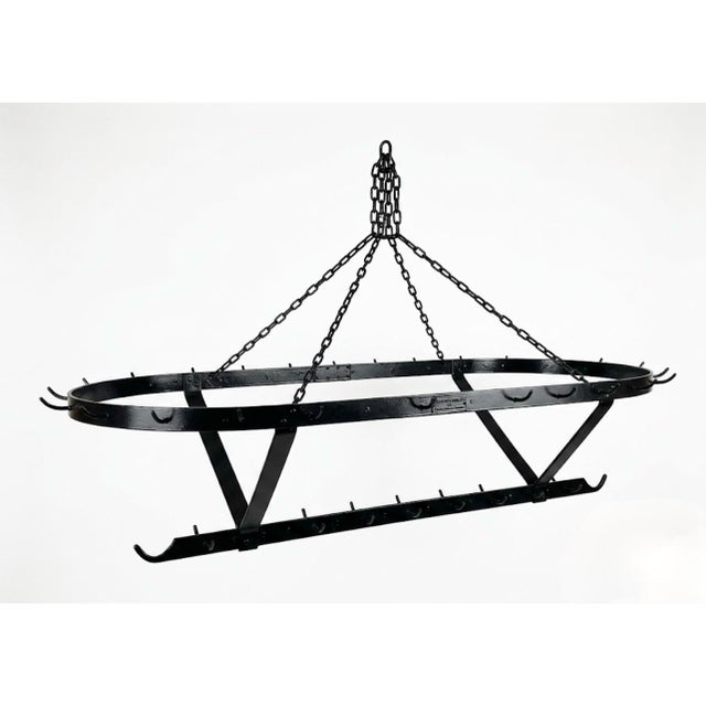 Elevate your kitchen architecture with this striking French Country hanging pot rack. Handcrafted from heavy-gauge forged...