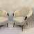 Pair of Danish 1950's armchairs, attributed to Nana Ditzel, reupholstered in Boucle wool have aerodynamic design...