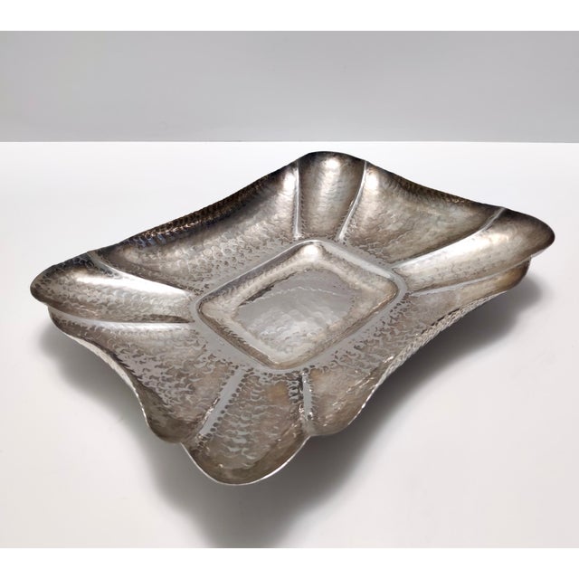 Made in Italy in 1950s. This tray / centerpiece is made in hand embossed silver plated metal. It is a vintage item,...