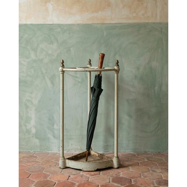 Presenting an appealing antique sectional corner umbrella stand crafted from brass and painted iron, featuring four...