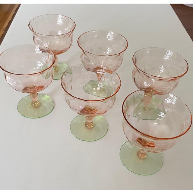 This set of pink depression glass compotes appears to be “Watermelon” glass, likely manufactured by companies like Tiffin...