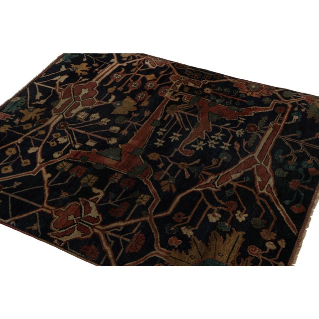 Hand-knotted in wool circa 1920-1930, this 4x5 antique Persian rug is a remarkable signature piece from our Antique...