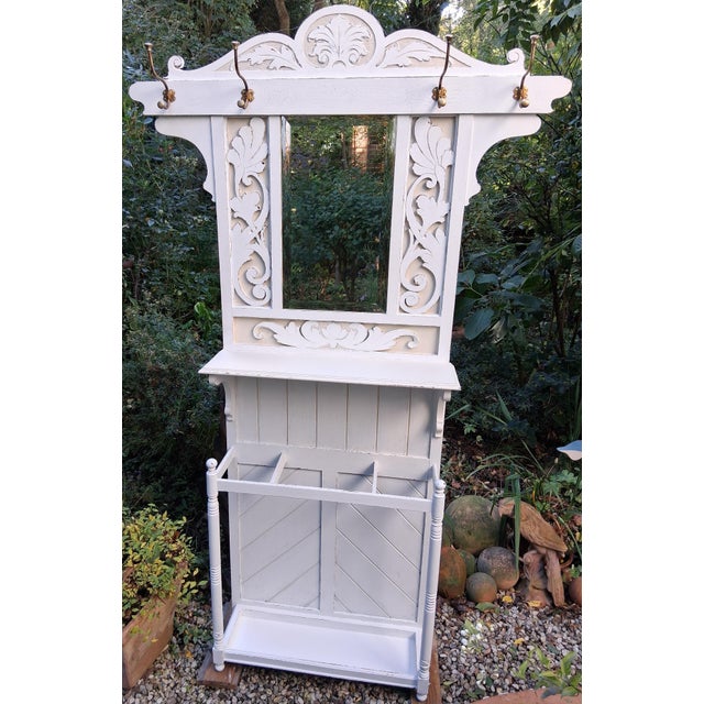 An unusual standing mirror from around 1900, made of oak, with rare decorative carvings depicting floral elements with...