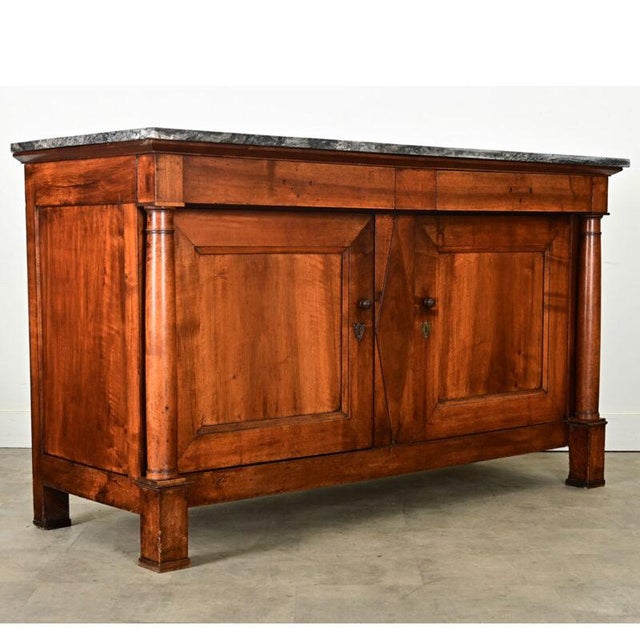 Dimensions: 42 ½” H x 72 ⅝” W x 28” D An impressive French Empire buffet made of figured walnut in a rich auburn hue that...