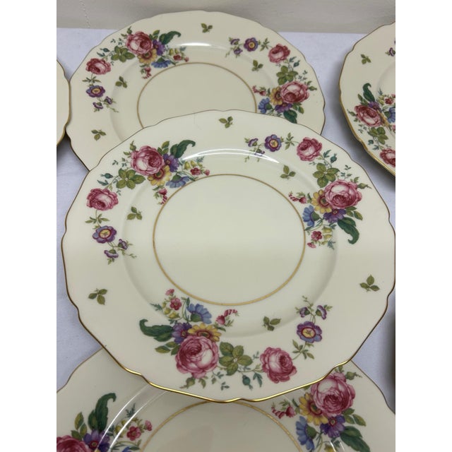 An exceptional and vibrant set of seven (7) antique fine porcelain dinner plates from the highly coveted Thomas Ivory...