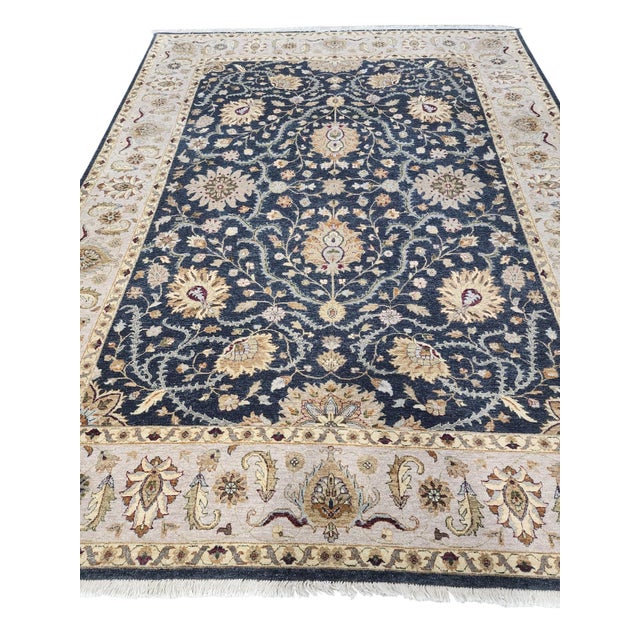 Indo-Persian Tabriz rug, hand-knotted in India from 100% wool with silk highlights. Measuring 9’ x 12’, the rug features...
