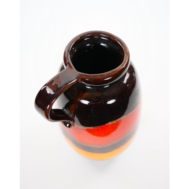 A striking mid-century West German drip lava glazed porcelain vase, beautifully showcasing the bold colors and modernist...
