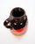 A striking mid-century West German drip lava glazed porcelain vase, beautifully showcasing the bold colors and modernist...