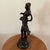 The product is an antique Italian bronze sculpture from the early 1900s, depicting a walking girl carrying a fruit basket....