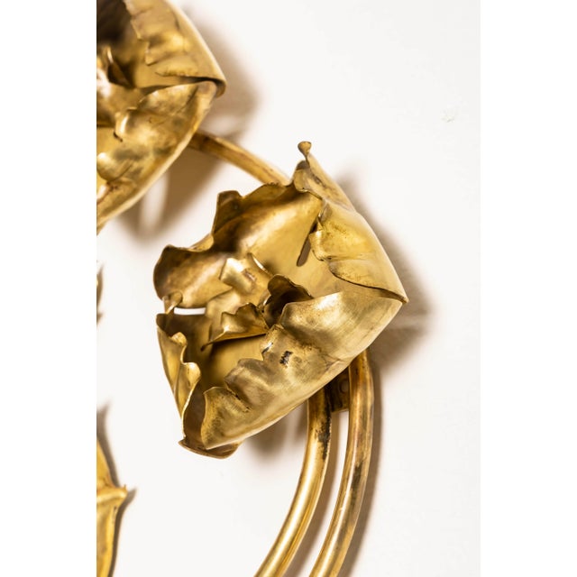 Large hammered brass wall sconce, France, early 20th century. The design translates a symbolic thistle/holly motif into...