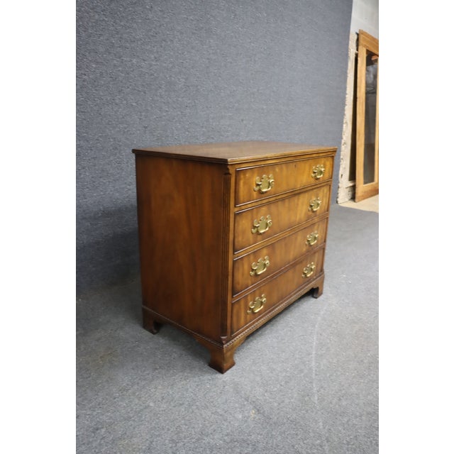 Mahogany bachelor chest by Kittinger Furniture Co., known for exceptional craftsmanship and their long-standing...