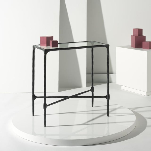 Introducing the Isabellina Metal and Glass Accent Table in black and clear. This sleek table combines modern design with...