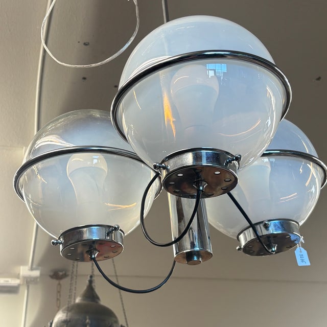 Sarfatti-style chandelier for Arteluce. 1970s design. Made with three shaded Murano glass bowls and a chrome-plated metal...