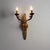 A cast bronze two-light wall sconce with an applique and leaf motif, designed by De Coene Frères from Belgium, circa 1930.