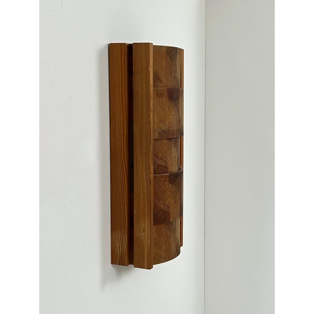 Large wall light made from assembled pieces of pine, produced in Sweden in the 1970s. Beautiful structure, soft and...