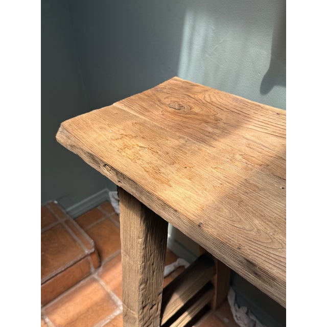 Crafted from solid reclaimed wood, this handcrafted console table showcases the natural beauty and character of aged...