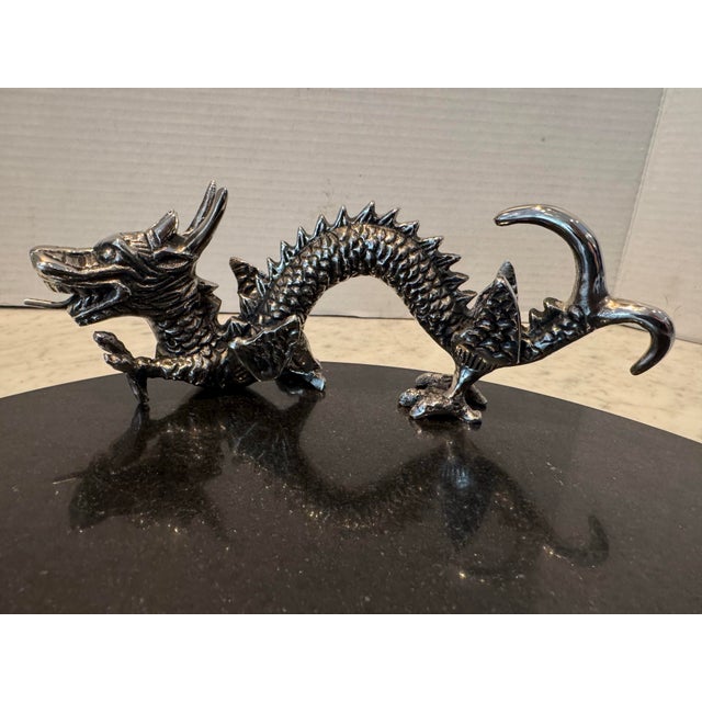A dramatic and unique serving tray in black marble by Natori. The tray is decorated with a nickel plated dragon. This is...