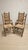 A charming set of six vintage wooden dining chairs featuring distinctive ladder-back backrests, turned uprights, and...