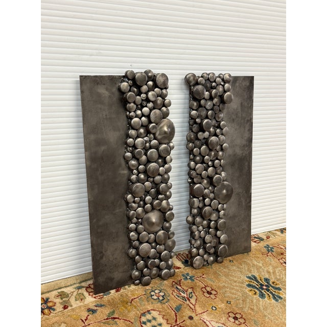 Design Plus Gallery presents a Set of Two Metal Rock Like Wall Sculptures. These two sculpted pieces are heavy metal with...