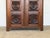 A carved oak two-door armoire, attributed to Charles Dudouyt, France, 1940s. The facade is dominated by six deeply carved...