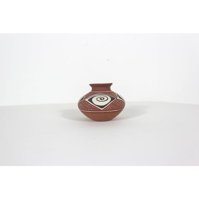 This is a small vintage clay art pottery vase from Venezuela. Signed on the bottom by the artist. This has some mild wear...