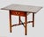 An elegant mahogany drop-leaf side table by Kindel Furniture of Grand Rapids, Michigan, crafted in the timeless Federal /...