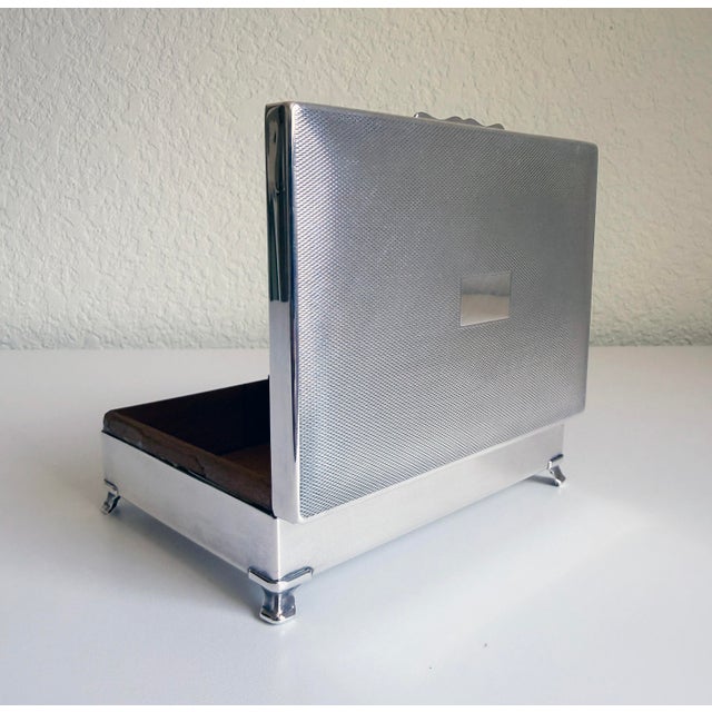 This vintage silver plate humidor box is a handsome example of timeless British refinement. It showcases intricate,...