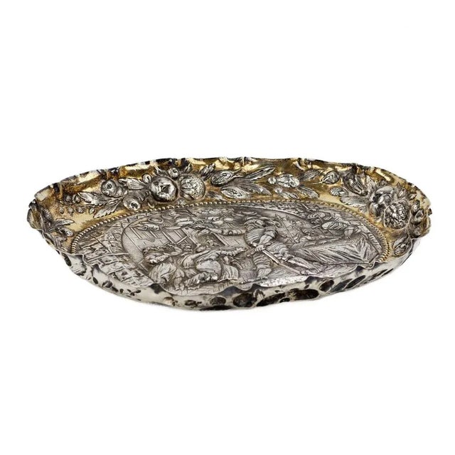 Silver, decorative dish with a scene of a feudal court. Allegory of wise government. The dish bears in an oval a...