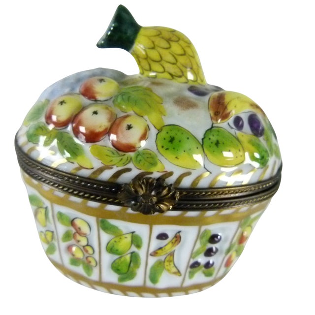 Limoges France Porcelain Fruit Basket Trinket Box. Commissioned by the renowned firm Limoges Imports, this "Fruit Basket"...