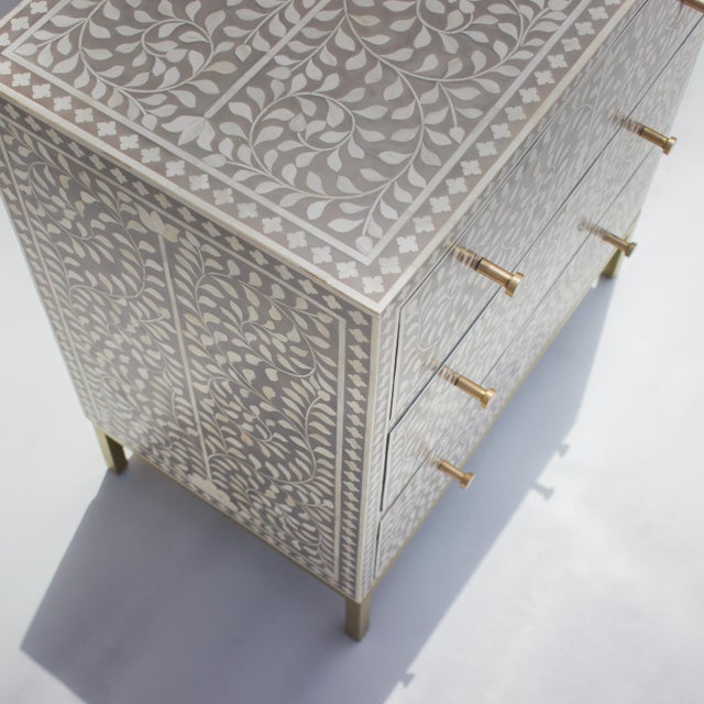 The Arabesque Blue Dyed Bone Inlay Four-Drawer Chest offers a distinctive interpretation of traditional floral...