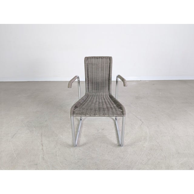 Beautiful Tecta D26E cantilever chair with armrests and gray wicker for sale. This design is considered a true classic and...